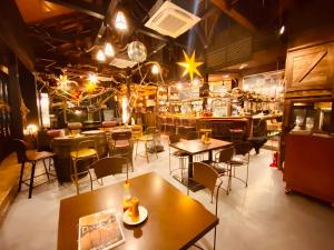 a restaurant with tables and chairs and a bar at Drive in Ichinomiya motel in Chosei