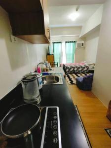 una cocina con fregadero y estufa horno superior en CityView Condo with balcony-12, en Cagayan de Oro 11 fotos más