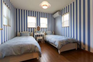 Letto o letti in una camera di Seaside House Enoshima 江ノ島, Free Parking 漫居湘南海岸, 尋訪灌籃高手