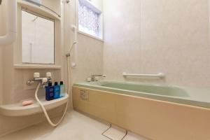 um banheiro com banheira e pia em Seaside House Enoshima 江ノ島, Free Parking 漫居湘南海岸, 尋訪灌籃高手 em Koshigoe mais 31 fotografias