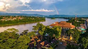 a view of a river with a building and a city at Chiangkhong Teak Garden Riverfront Hotel in Chiang Khong