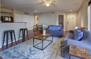 a living room with two blue couches and a table at Lovely 2 bedroom, 1 bath condo with pools and gym. in Houston