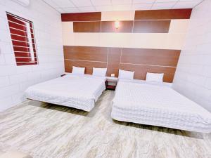 Ένα ή περισσότερα κρεβάτια σε δωμάτιο στο Khách sạn Ngọc Bích 2