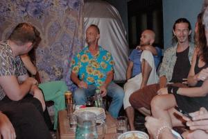 a group of people sitting in a living room at Nature Rex Hostel in Weligama