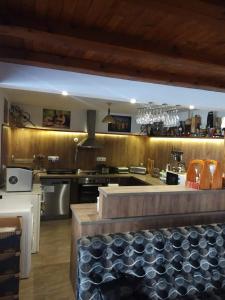 a large kitchen with a counter in the middle at NIKI HOUSE in Bansko