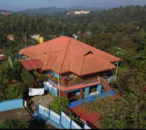 an overhead view of a house with an orange roof at Hill View Homestay Madikeri Coorg in Madikeri