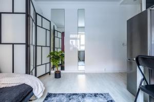 a room with a bed and a potted plant at Sailor`s Apartment in Helsinki