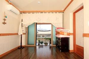 a living room with a room with a window at Byeolha Guesthouse in Jeonju