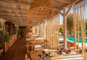 een patio met tafels en stoelen en een zwembad bij Can Aisha - Adults Only in Es Pujols