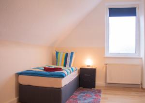 um pequeno quarto com uma cama e uma janela em Bis 5 Personen, Parkplatz, Arbeitsplatz em Solingen