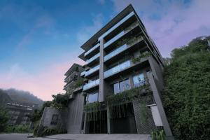 a tall building with plants on the side of it at Rivora Heights in Kandy