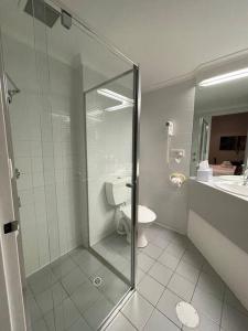 a bathroom with a shower and a toilet and a sink at city ex hotel ensuite room in city 408 in Adelaide