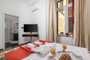 a room with a table with a plate of food and two glasses at Continentale - Deluxe Rooms in Rijeka