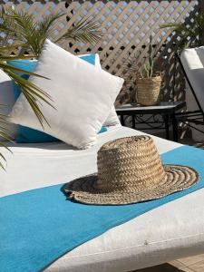 a straw hat is sitting on a bed at Riad Dollar Des Sables & Spa in Marrakesh