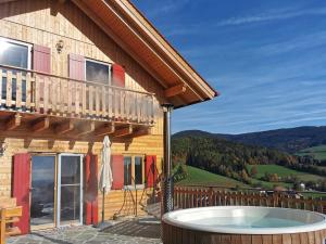a hot tub on the patio of a house at Bergchalet am Waldrand - Pool, Sauna & Kamin in Pöllauberg