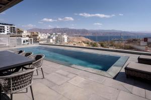 a swimming pool on the roof of a building at YalaRent Red Sea glory villa-private pool & jacuzzi in Eilat