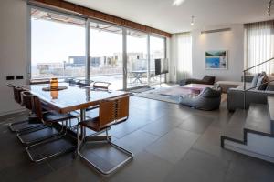 a living room with a table and chairs and a couch at YalaRent Red Sea glory villa-private pool & jacuzzi in Eilat