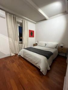 a bedroom with a large bed and a wooden floor at Mount Flower Trastevere Apt in Rome