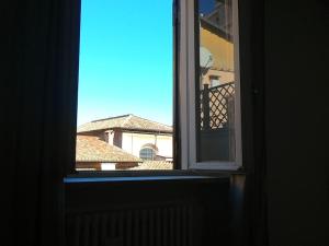an open window with a view of a building at Mount Flower Trastevere Apt in Rome