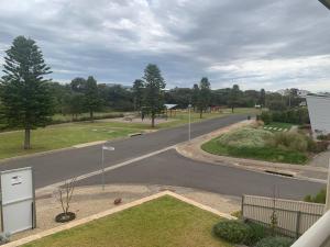 an empty road with trees on the side of the road at The Beach House in Middleton