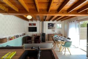 cocina y sala de estar con fregadero y mesa en La Reinette du Verger 9 d'Arry 1, en Arry