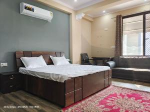 a bedroom with a large bed and a couch at OSHO Villa Guest House in Jaipur