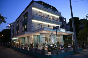 a building with potted plants in front of it at Hotel Alabama in Riccione