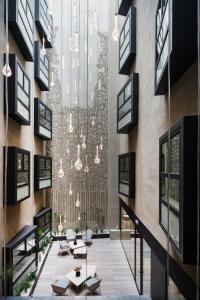 a lobby of a building with a chandelier at Catalonia Magdalenes in Barcelona