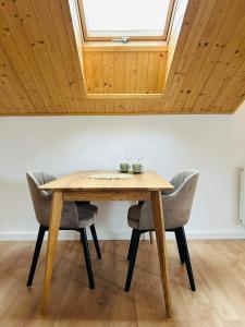 a dining room table with chairs and a skylight at V ulicke in Kežmarok