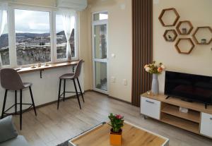 uma sala de estar com uma televisão e uma mesa em Apartment Colibri em Veliko Tarnovo