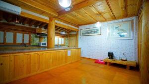 a kitchen with a counter and a table in a room at Kumwondang Jeonju Hanokstay in Jeonju