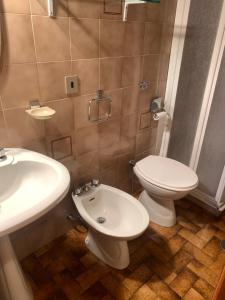 a bathroom with a toilet and a sink at Residence il Cristallo - Appartamento in Ovindoli