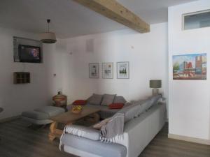 a living room with a couch and a table at La Pommeraie in Casteil