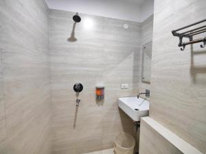 a bathroom with a sink and a toilet and a mirror at Hotel 21 Next To Chd Railway Station in Chandīgarh