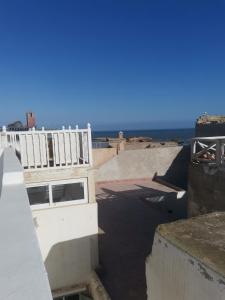 a view of a building with the ocean in the background at Dar Traa in Essaouira