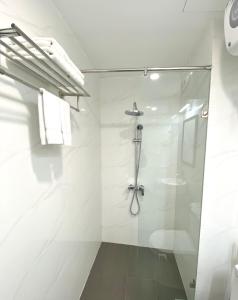 a bathroom with a shower with a glass door at Tien Minh Hotel 113 Le Thanh Nghi in Hanoi