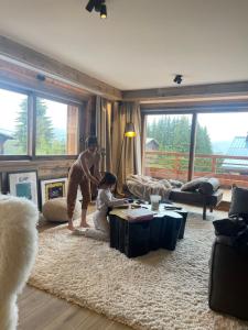 two children are playing in a living room at Standing Megeve - 2 to 8 people - Mont d'Arbois in Megève