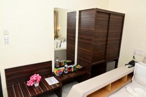 a hotel room with a mirror and a table at VITS Shanti Solitaire, Arpora in Arpora