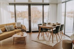 a living room with a couch and a table at Waidlerland Hausboot 1 in Waldkirchen