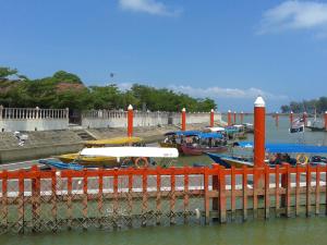 a bunch of boats are docked at a dock at IZ Budget in Kampung Kuala Besut