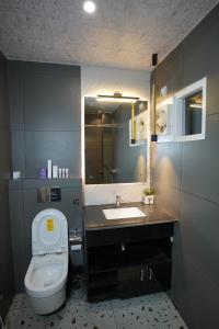 a bathroom with a toilet and a sink at The Royal Hotel in Haldwāni