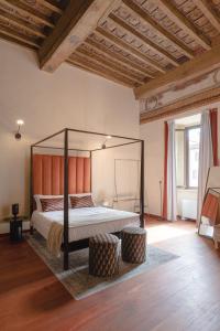 a bedroom with a canopy bed in a room at Torre Capranica in Rome