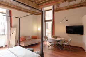 a bedroom with a bed and a table and a couch at Torre Capranica in Rome