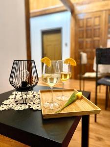 two glasses of wine sitting on a table at Ruralna kuća za odmor Klet Karas in Kozarevac