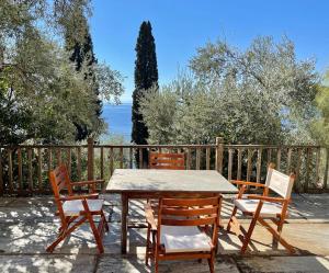 a wooden table and chairs on a patio at Beachfront Villa Rodi Pelion in Kato Gatzea