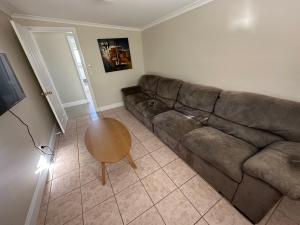 a living room with a couch and a table at Charming 3 bedroom Workers Accommodation in Grafton