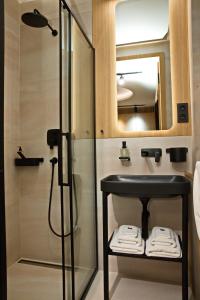 a bathroom with a sink and a shower at Mama's Design & Boutique Hotel in Bratislava
