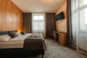 a bedroom with a large bed and a window at Hotel Lípa in Dolní Lipová