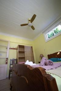 a bedroom with a ceiling fan and a bed at Old Town House at Lefkada city in Lefkada Town