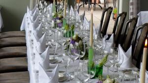 a long table with wine glasses on it at Restaurant und Hotel Zum Weissen Ross in Mölln